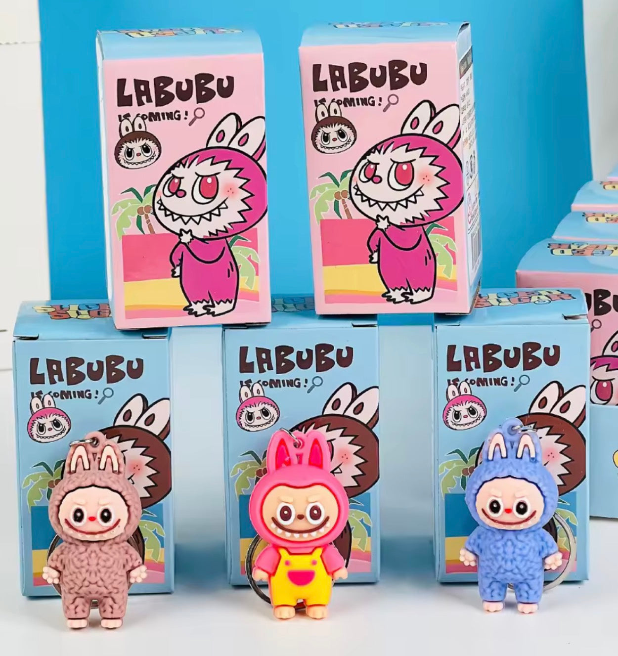 Labubu toy figures and packaging on a white and blue background