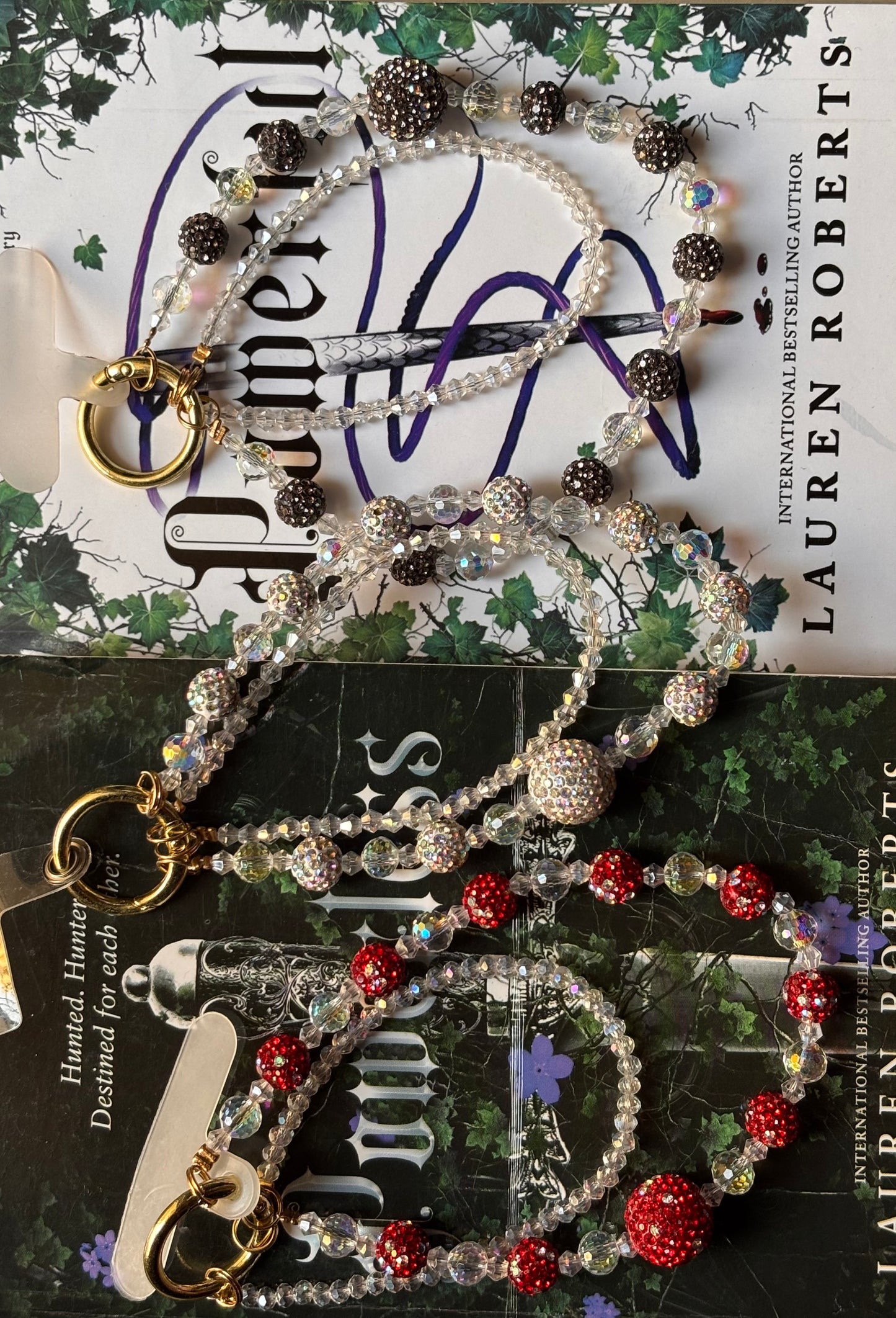 Set of beaded keychains on a book with visible branding