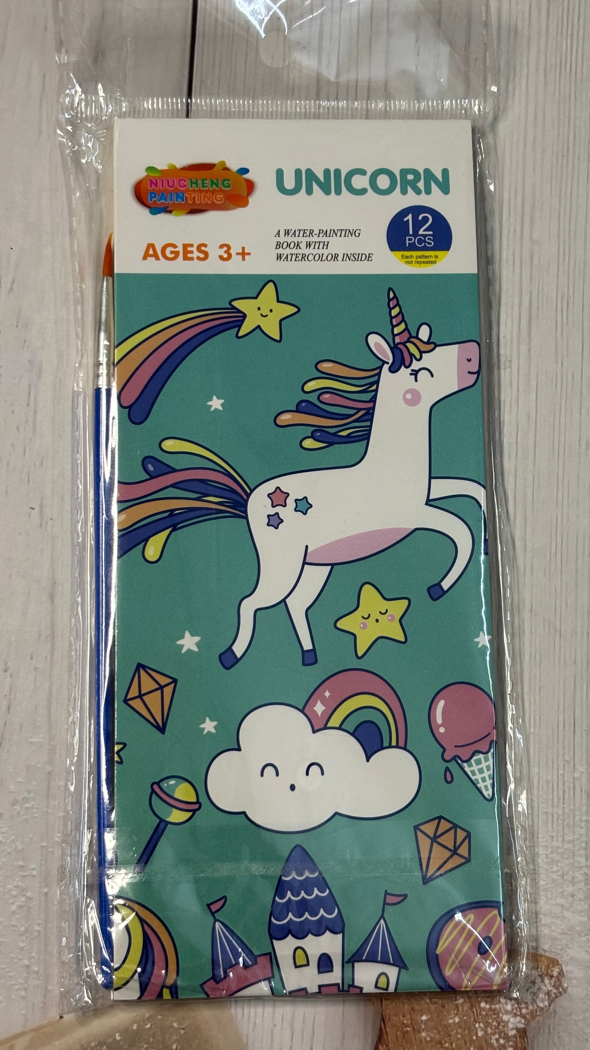Packaged children's coloring book with unicorn design on a teal background