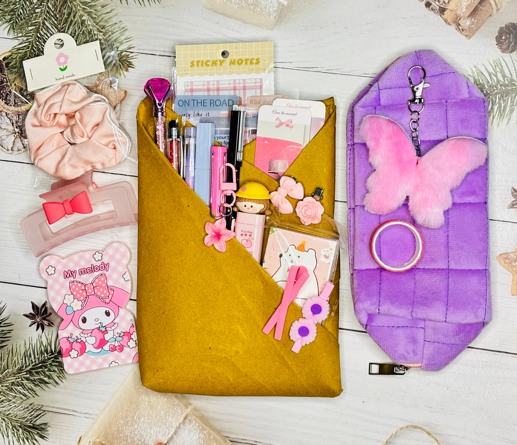 Collection of stationery items including a yellow pouch, pink butterfly keychain, and various small accessories on a white surface.