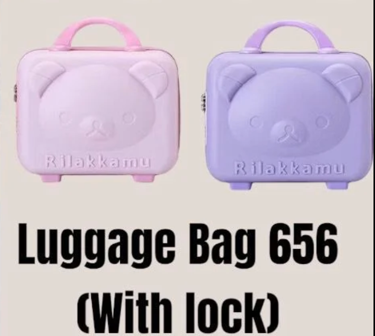 Four bear-shaped luggage bags in different colors with 'Rilakkuma' branding.