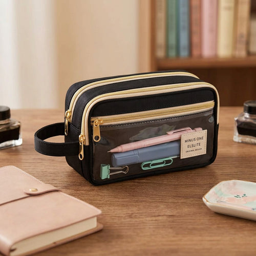 A black and beige double-compartment toiletry bag with a clear front pocket and a black carrying strap, shown on a white background.