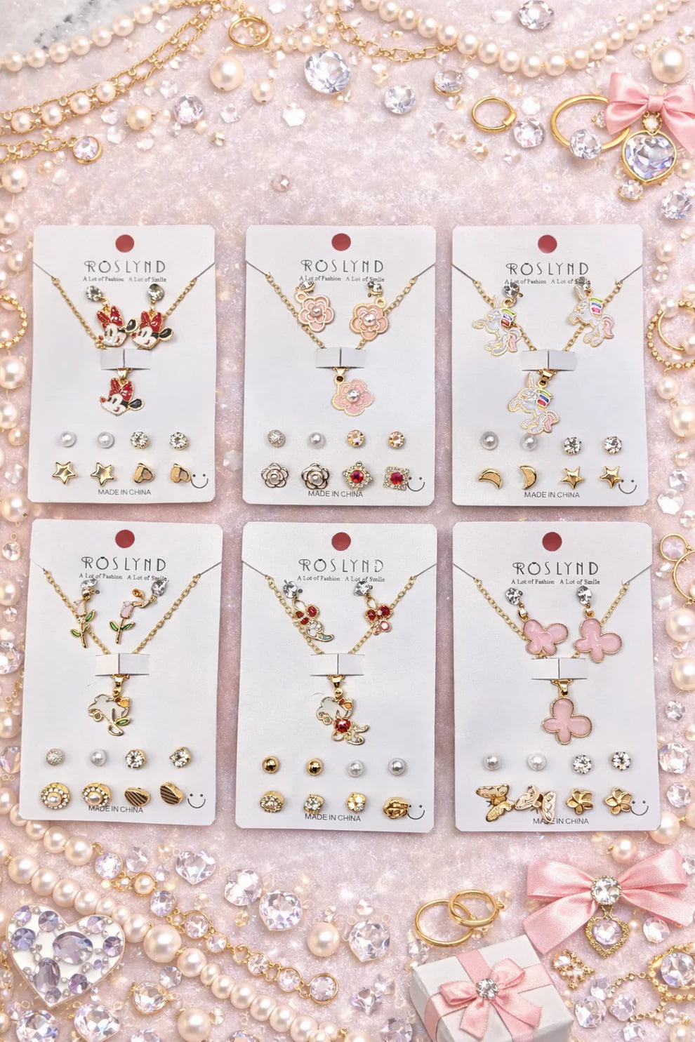 Set of Roslynd jewelry on display with necklaces, earrings, and pendants.