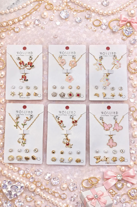 Set of Roslynd jewelry on display with necklaces, earrings, and pendants.